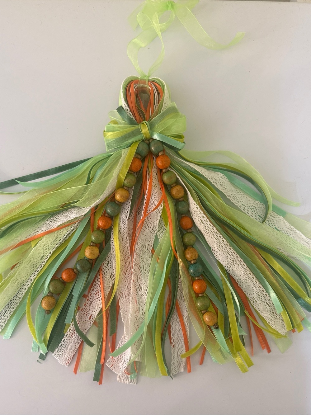 Rear view car mirror tassle with ribbon and wooden beads.